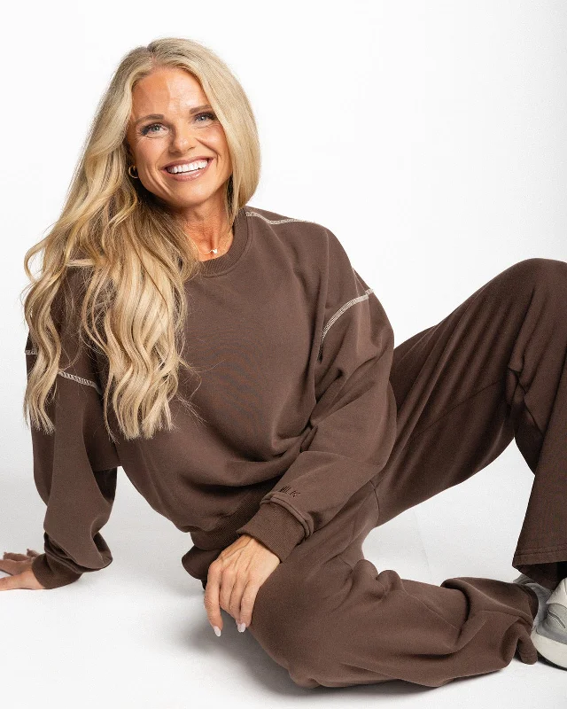 Women's hoodie with a kangaroo pocket and a pom - pom drawstring for added charmMilkstain x Lisa Wilson Crew Women's hoodie with a kangaroo pocket and a pom - pom drawstring for added charmMilkstain x Lisa Wilson Crew